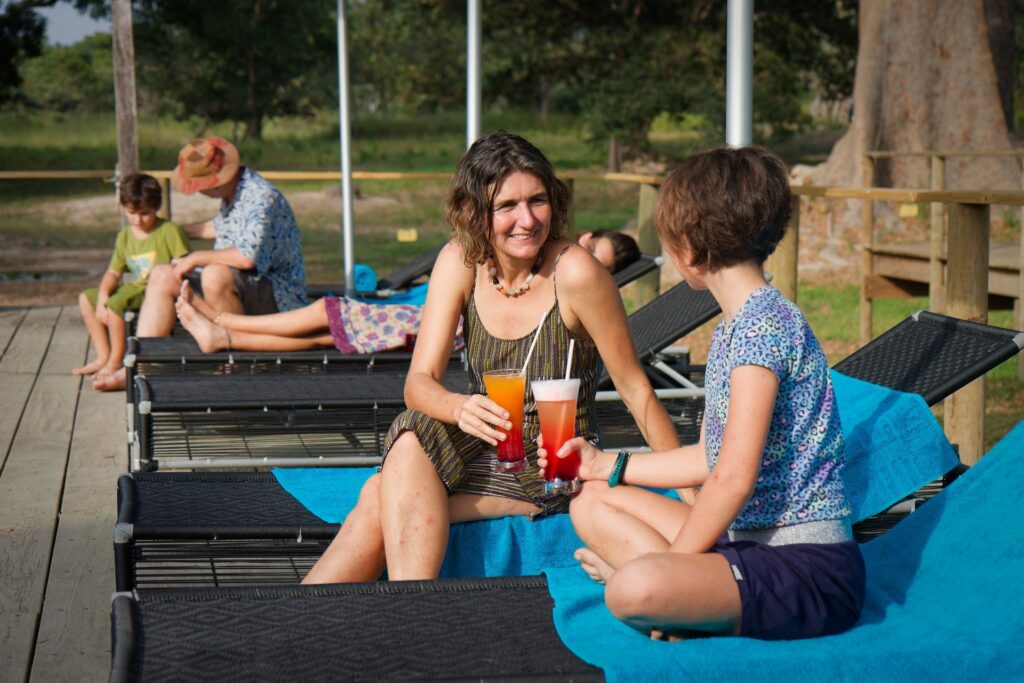 Clients se détendant sur des transats à Fathala Lodge, cocktails à la main